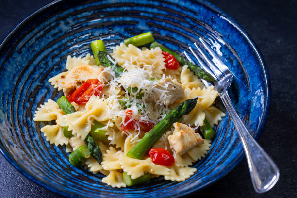 istock Farfalle pasta with green asparagus, cherry tomatoes and chicken 2197230905