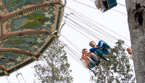 istock Children having fun on a swing ride at an amusement park 2197231883