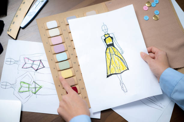 istock A female designer is creating clothing designs in her studio. 2197231917