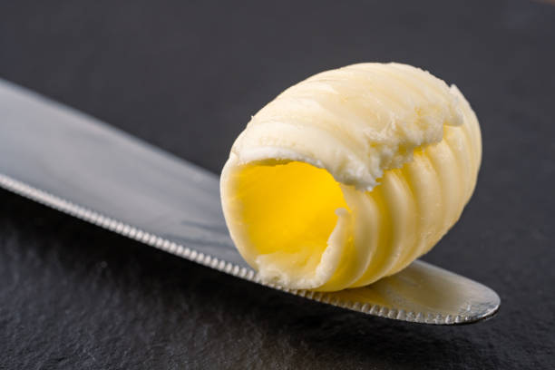 Butter spread, kitchen knife with country butter, appetizing view