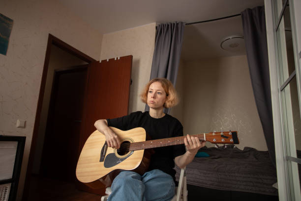 istock Guitar lessons at home, hobby of strumming and melody, person developing performance skill in leisure time. 2197233102