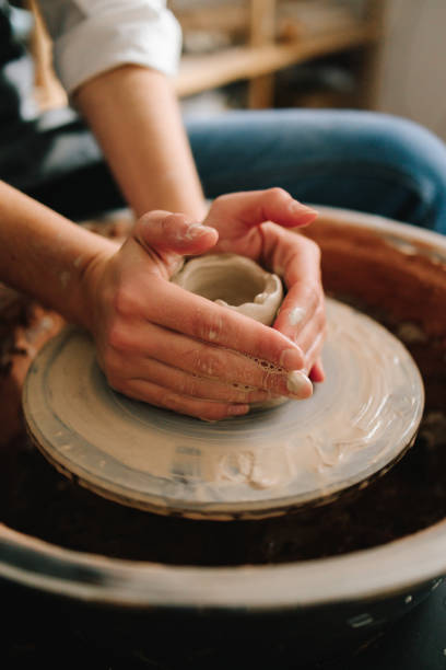 Potter creates a ceramic bowl in the pottery studio. Process of making a unique ceramic shape.
