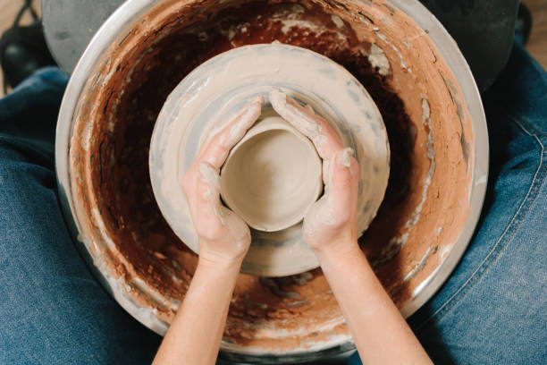 istock Process of making a unique ceramic shape. Potter creates a ceramic bowl in the pottery studio. 2197233348