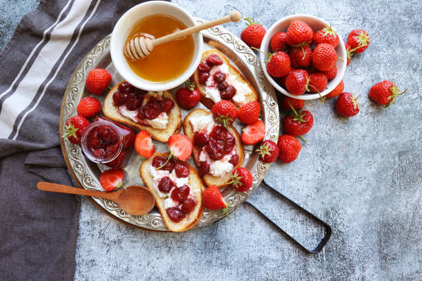 istock Sandwich with strawberries, soft cheese,  and honey on  grey background. Top view. 2197234185