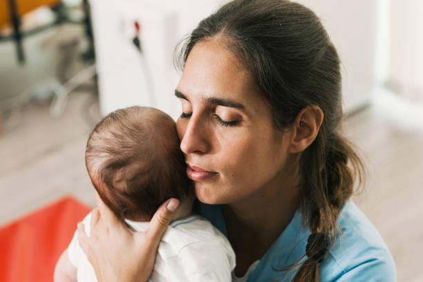 istock Physiotherapist holding a baby during physiotherapy session 2197234557