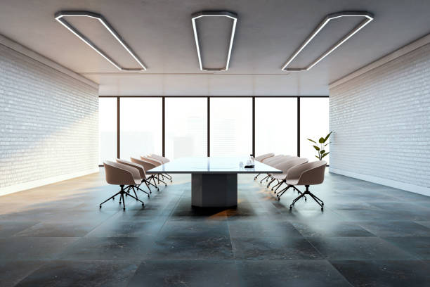 istock Modern conference room with large table, chairs, and city view through glass windows, featuring brick walls and contemporary lighting. 3D Rendering 2197239620