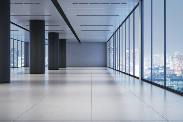 istock Modern office corridor with glass windows overlooking cityscape at night. 3D Rendering 2197239824