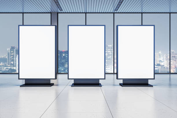 istock Three blank digital displays in modern office interior with city view at night through glass windows. 3D Rendering 2197239825