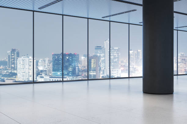 istock Modern office corridor with large glass windows overlooking a panoramic city view at night, featuring sleek design and bright lighting. 3D Rendering 2197239827