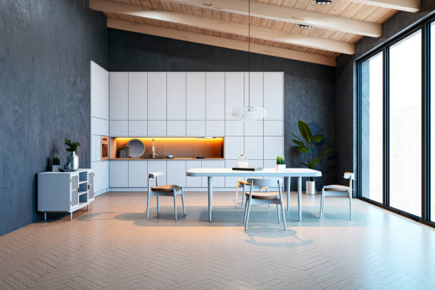 istock Modern empty kitchen interior with dining table, chairs, and cabinets in a loft-style apartment with city view through large windows. 3D Rendering 2197240399
