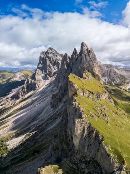 istock Drone vertical panorama of Seceda ridge in the Dolomites, showcasing jagged cliffs, green alpine meadows, and sweeping mountain views 2197244488