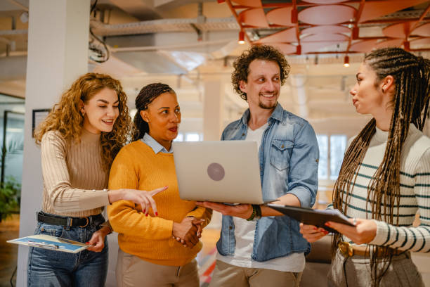 istock diverse group businesspeople stand and use laptop in the office 2197248492