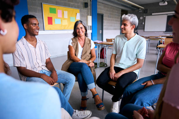istock Diverse group of high school students sitting on chairs in a circle and interacting during a lesson 2197248575
