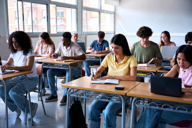 istock A diverse group of multiracial students aged 18 to 20 in a classroom, attentively taking notes 2197248926