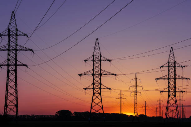 istock A sunset is reflected in the sky above a field of power lines 2197249721