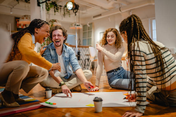 istock multicultural colleagues gather around a large paper on a wooden floor 2197249869