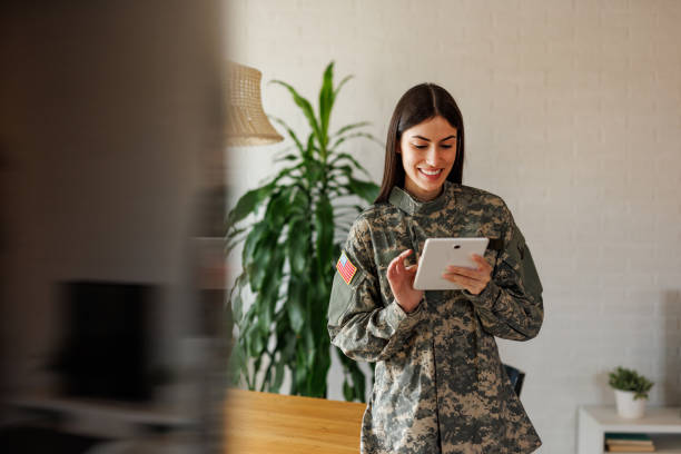 istock Smiling US Army Soldier Using Tablet at Home 2197254269