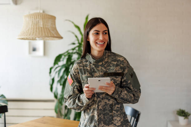 istock Smiling U.S. Army soldier using digital tablet at home 2197254275