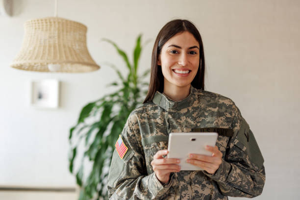 istock Smiling U.S. Army soldier using digital tablet at home 2197254276