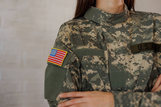 istock Proud U.S. Army soldier wearing camouflage uniform with American flag patch 2197254301