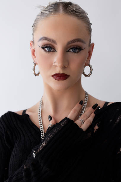 Young woman with make-up on posing against white background