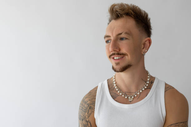 Young male looking away and smiling against white background