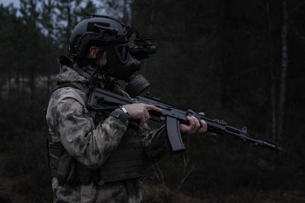 istock Soldier in a gas mask with night vision device in a post-apocalyptic forest. 2197256964
