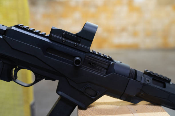 Modern tactical red dot sight mounted on a carbine with a picatinny rail.