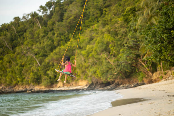 istock Swinging Child in Serene Natural Setting 2197258791