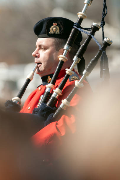Halifax, Canada - April 15, 2012: A bagpiper with the Royal Canadian Mounted Police plays Amazing Grace at the 100th anniversary Titanic memorial service at Fairview Lawn Cemetery where 121 passengers of the ill-fated ship are laid to rest.