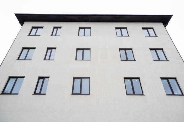 An imperfect simple house with different windows at front