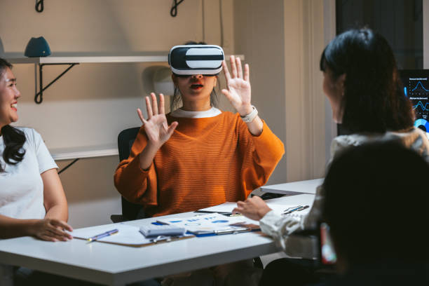 istock Asian businesswomen engaging in a meeting while using virtual reality headsets, immersing themselves in the metaverse and discovering new market opportunities for growth and innovation 2197261004