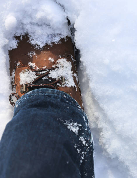 istock man wearing leather hiking boots covered in fresh snow after blizzard snowfall (brown work boot with blue jeans winter) snowy hike outdoor northeast united states white ice frozen powder skiing men's 2197262913