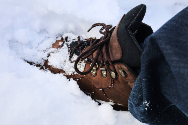 istock man wearing leather hiking boots covered in fresh snow after blizzard snowfall (brown work boot with blue jeans winter) snowy hike outdoor northeast united states white ice frozen powder skiing men's 2197263193