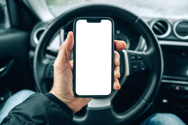 istock Smartphone mockup screen, male driver using mobile phone in car on cold winter day 2197263812