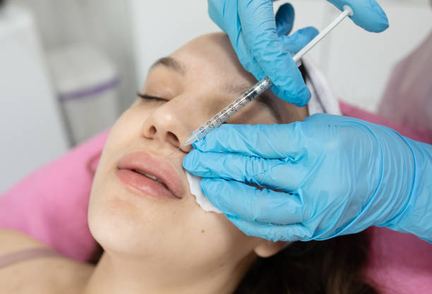 istock Woman is getting filler injection in lips. 2197265326