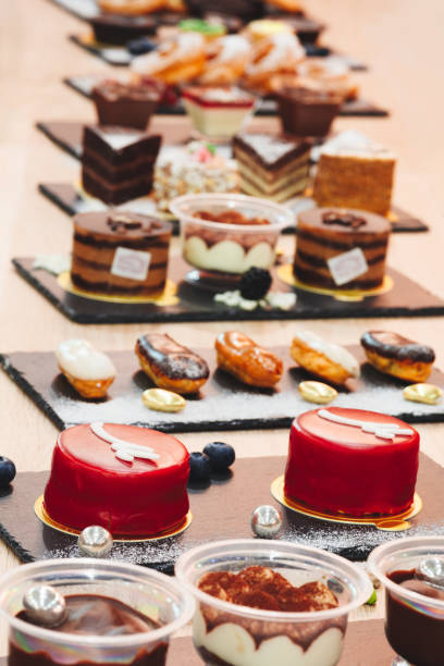 istock A table with many desserts including cakes and donuts. There are also some containers with different types of desserts 2197266273
