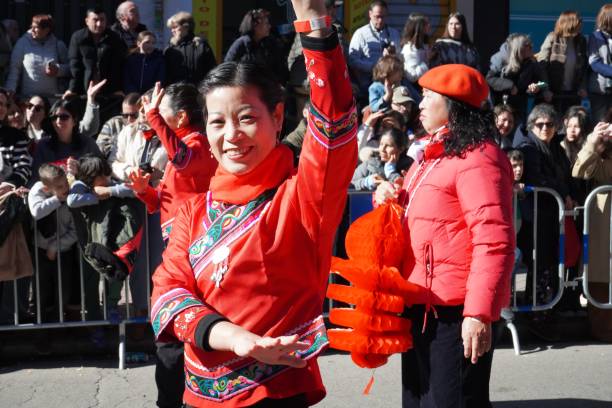 Madrid, Spain, February 2, 2025. People participating in the Chinese parade day with traditional dresses, celebrating the Year of the Snake.