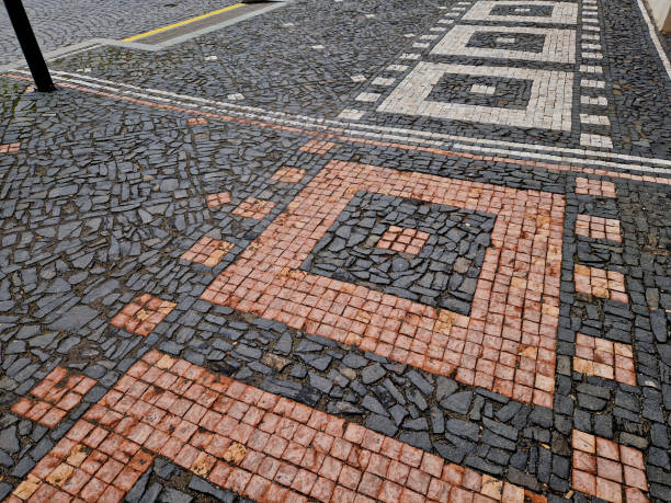 istock ripples pattern from mosaic cubes on black rough pavement. squares and dashed lines. promenade in the square with repeating lines of the shape of waves and hearts 2197267094