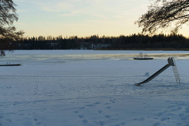 Beautiful sunset at lake with ice in Sweden. Nice winter evening in Swedish nature and landscape.