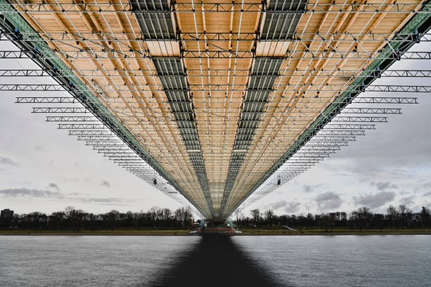 Exploring the architectural design of a large bridge structure during a cloudy day over calm waters