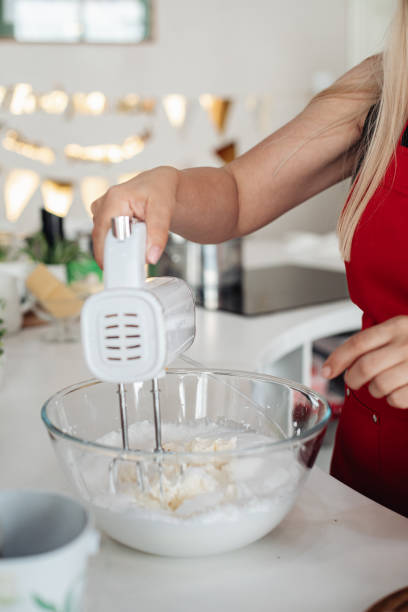 istock Women's hands prepare the cream using a mixer 2197274651