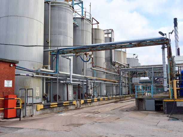 Industrial plant with large storage tanks and intricate piping system.