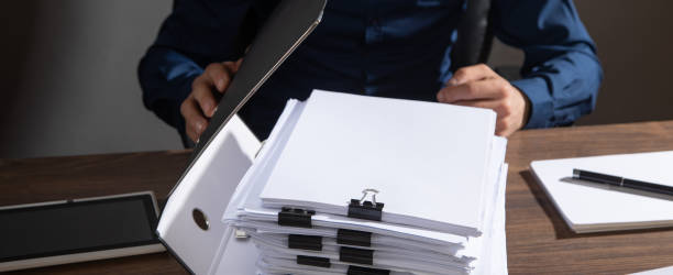 istock Caucasian businessman holding documents in office. 2197278420