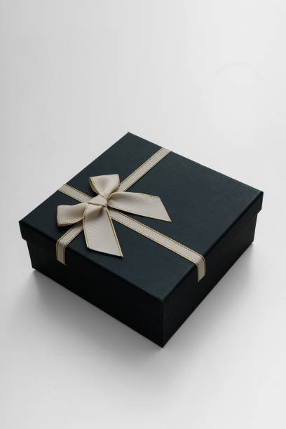 istock Dark celebrated gift box lie on white background 2197281990