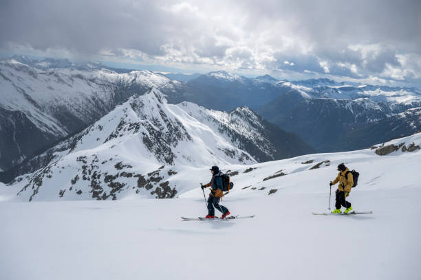 istock Backcountry skiers ascend snowcapped mountain 2197283299