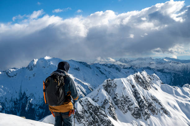 istock Backcountry skier pauses on mountain top 2197283498