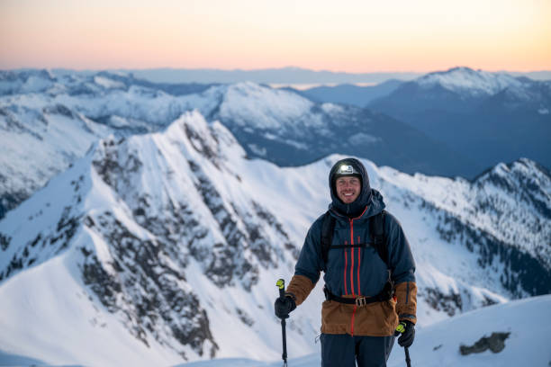 istock Backcountry skier ascends snowcapped mountain 2197283527