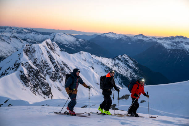 istock Backcountry skiers ascend snowcapped mountain 2197283603