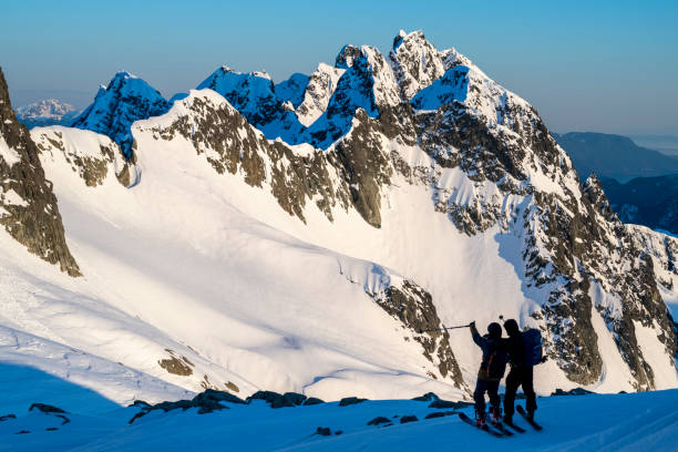 istock Backcountry skiers pause on mountain top 2197283786
